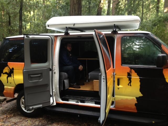 The campervan's interior seating area folds down to a bed, while the rooftop sleeper expands into a second tented sleeping area