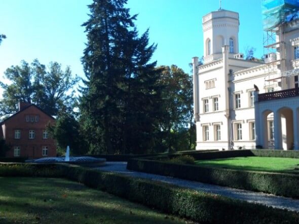 The other side of the main palace sits across from the brick office and a landscaped yard