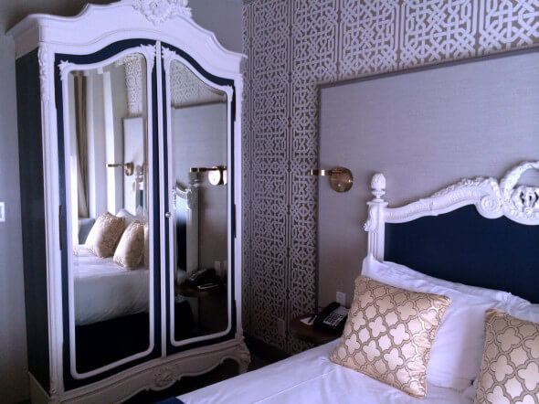 A deluxe room with the original 1913 armiore and headboard