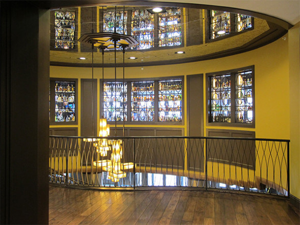 The bar (reflected in the mirror above the staircase) is on the other side of the "window".