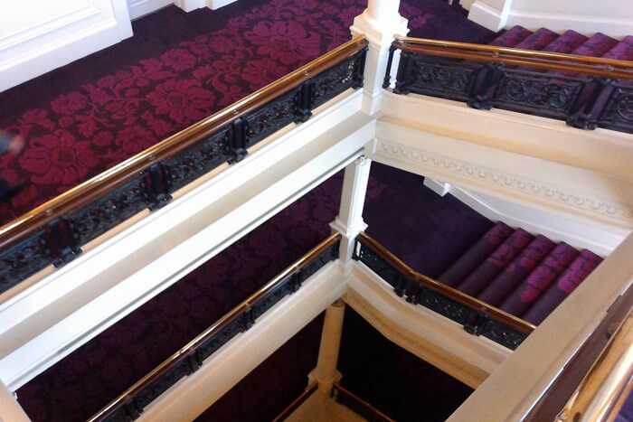 on the grand staircase at Amba Charing Cross