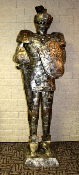 A knight's armor greets guests at check-in.