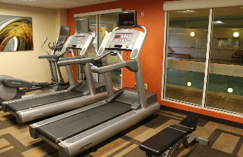 The fitness center overlooks the pool