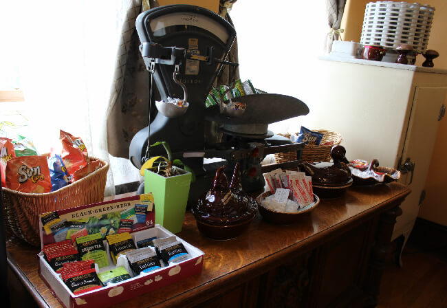 An antique scale serves as a granola bar bowl and a candy dish