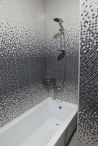 tiled bathrub and shower at Karagat Hotel