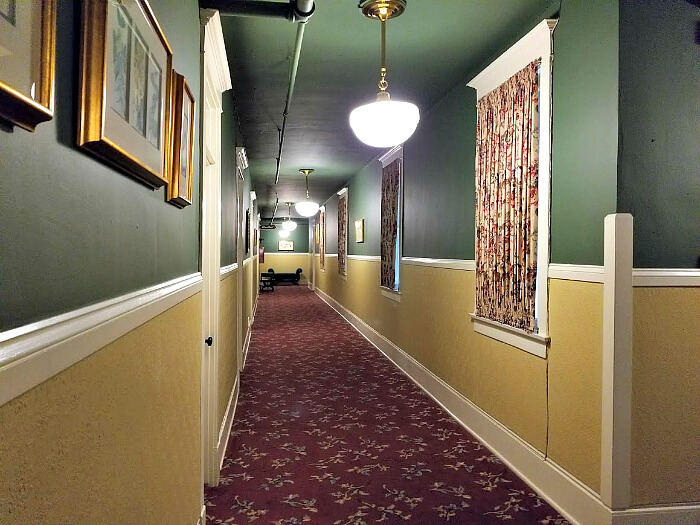 The hallways of the Hotel Boulderado include historic elements including ornate wallpaper, artwork and photography.