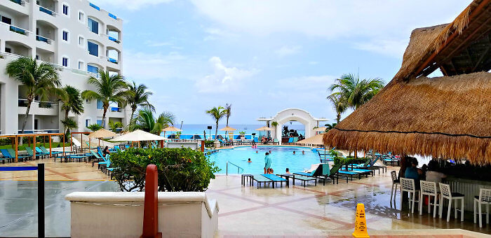 Step out of the lobby area into a view of pools and ocean at Panama Jack Resorts Cancun.