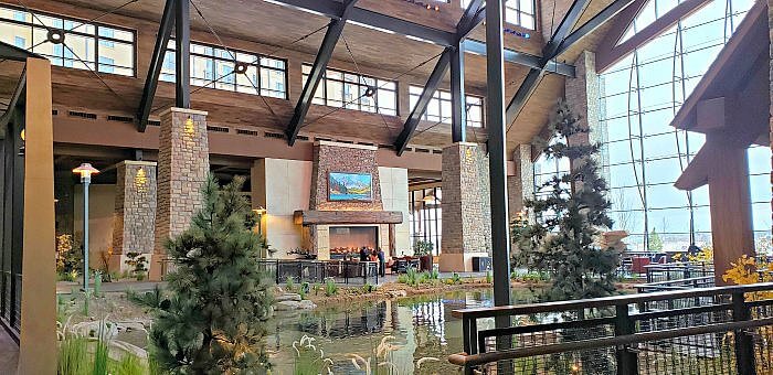 Gaylord Rockies resort & Convention Center, grand lodge and fireplace area near dining opintions and water feature.