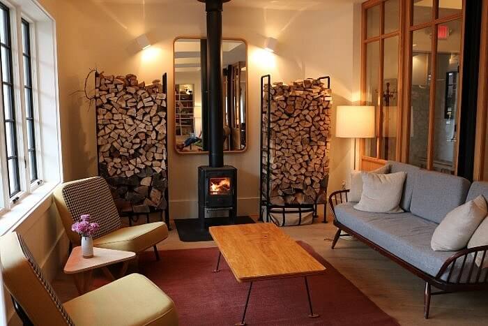 Common area with wood stove in Rivertown Lodge in Hudson, NY