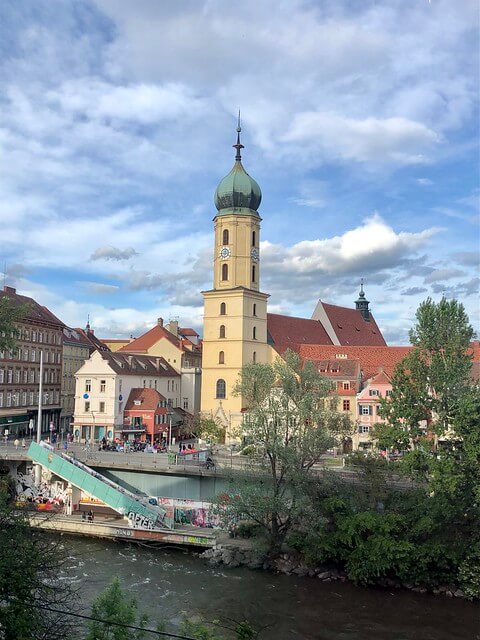 church, river mur, graz austria rooftops