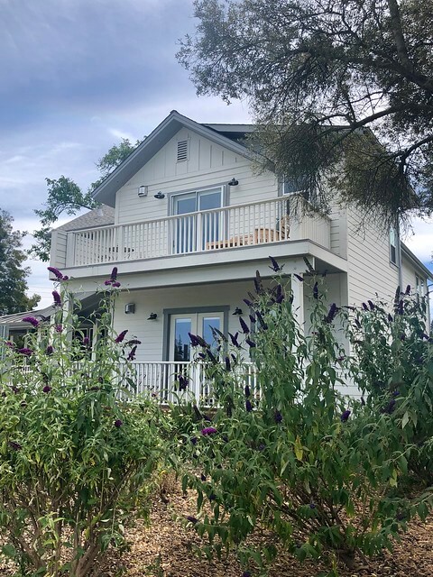 Purple butterfly bush plants frame the side of The Setting in Napa Valley.