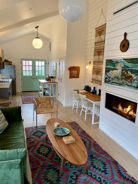 The interior of The Bungalows at Calistoga are tastefully decorated with horse-themed art, gas fireplace and all white paint.