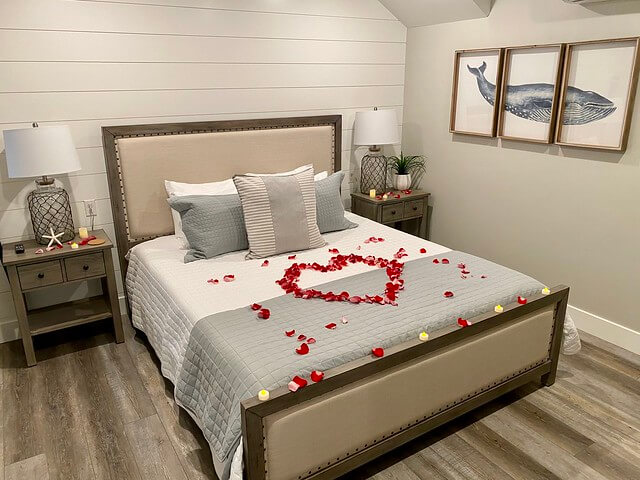 Rose petals in the shape of a heart are arranged on the bedspread in one of six suites.