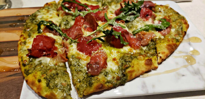 Dining at lobby bar restaurant at Hyatt Place Pena Station on P & S Flatbread, prosciutto, mozzarella & parmesan, basil.pesto, tomatoes, lemon-dreased arugula! Seriously that pesto with drizzle of honey! Photo: Diana Rowe