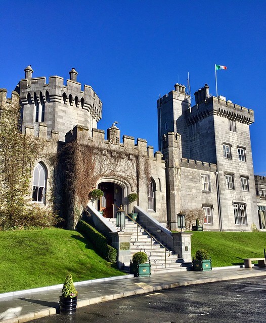 Dromoland Castle exterior from the front of the castle with blue sky in Ireland