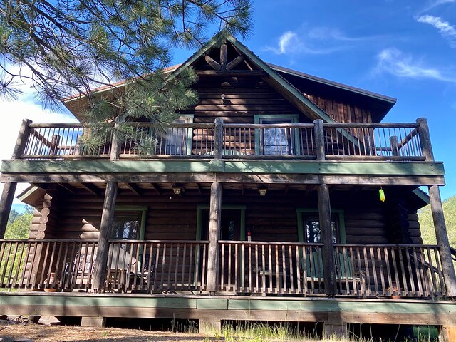 The two-story Eagle's Nest Cabin in a log cabin that sleeps 6-8 in four king suites.