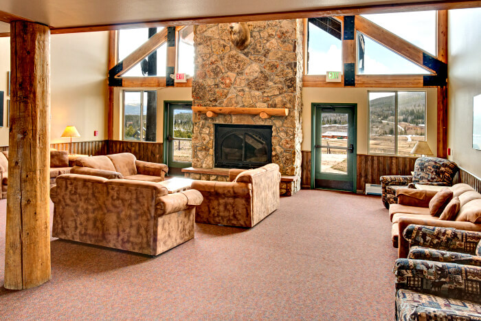 The entrance to Indian Peaks Lodge opens onto a high-vaulted social area with fireplace and relaxed seating. Photo: YMCA of the Rockies