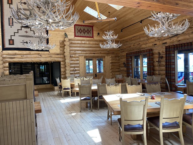 Elk shed chandeliers hang from the log cabin ceiling in the dining room of Silvies Valley Ranch in eastern Oregon. 