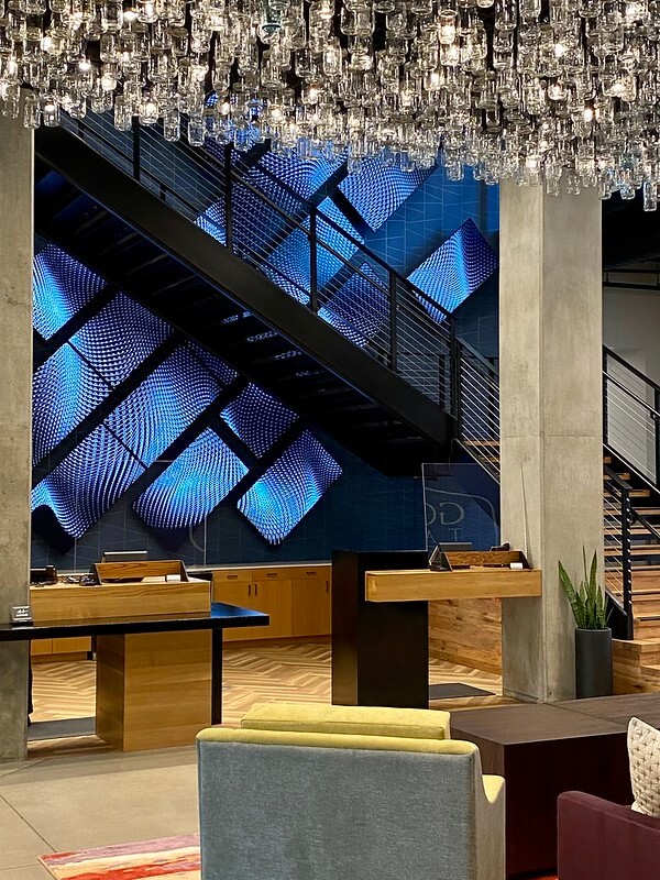 The large-format digital art installation called the Great Wall towers behind reception at The Gordon Hotel.