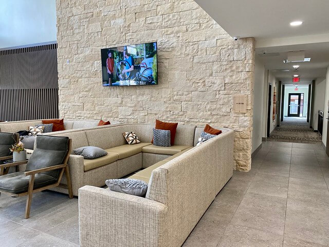 Sofa lounge area in Element Moab with flat screen tv in the hotel lobby