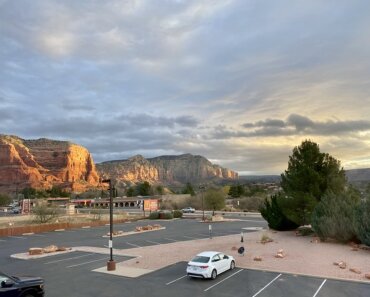 Holiday Inn Express Sedona Oak Creek parking lot with Red Rocks of Arizona.