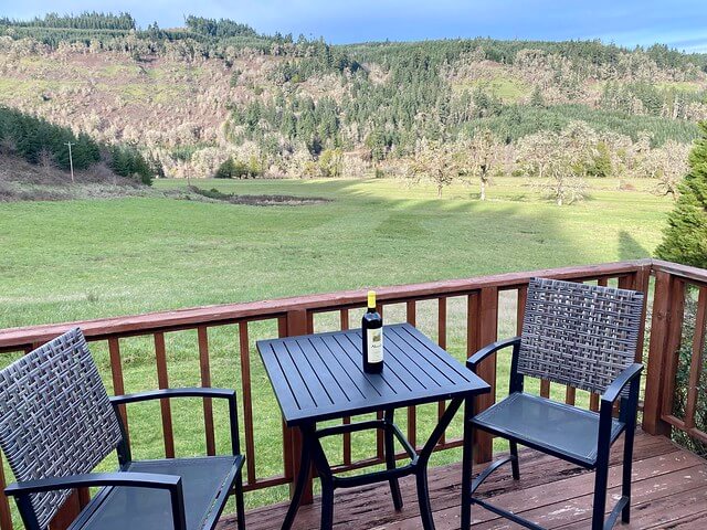 Bottle of Umpqua Valley wine on the table for wine tasting on the patio.