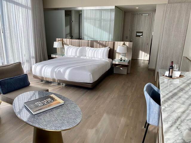 King bed, marble counter desk and silver walnut wood floors. 