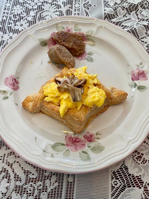 Eggs Vol Au Vents with puff pastry on a china plate at Heceta Lighthouse Bed and Breakfast