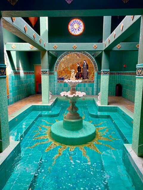 Mosaic-tiled soaking pool with fountain in Old St. Francis School House