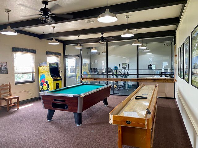 Far view lodge game room with pool table, shuffleboard and video game in Mesa Verde National Park.