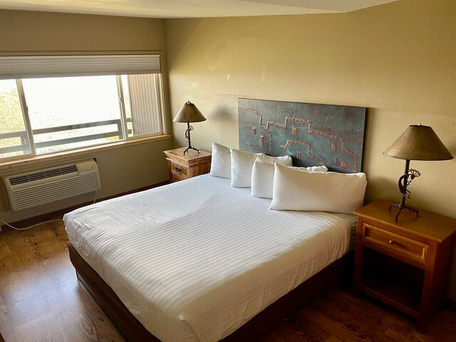 A southwestern metal headboard rests at the base of the king bed in the Kiva room at Far View Lodge. 