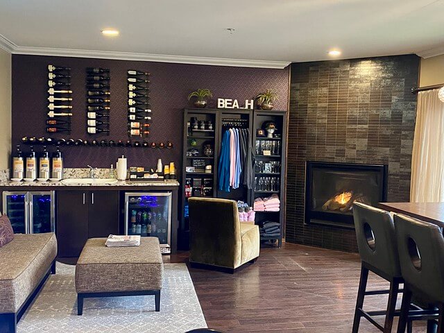 Inn at Nye Beach Newport lobby with fireplace, local coffee and wine. Mini fridge with sodas under the counter.