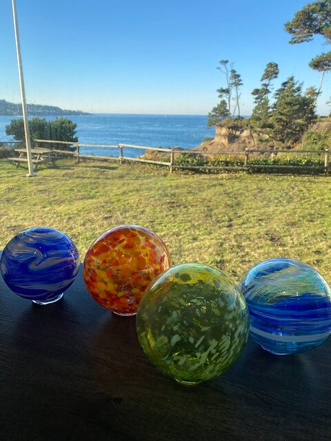 Four glass float balls are on display in the Depoe Bay hotel lobby at Inn at Arch rock.