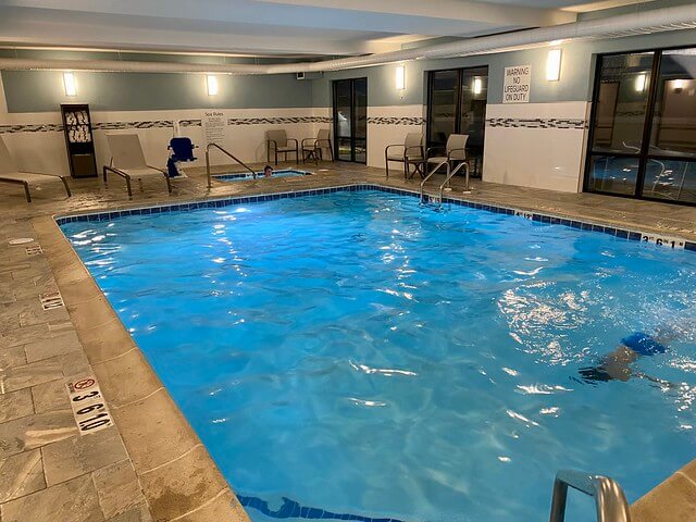 Unidentified child swims underwater in the hotel's indoor swimming pool. His older brother sits in the hot tub at the Grand Junction hotel.