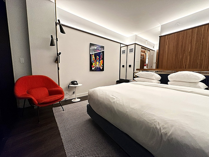 Guest room at TWA Hotel with king-size bed and red Womb Chair