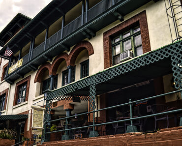 The four-story red, green and cream facade of the Copper Queen Hotel