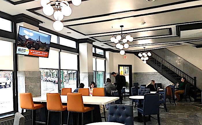 Best Western Syracuse lobby seating area with high and low tables.