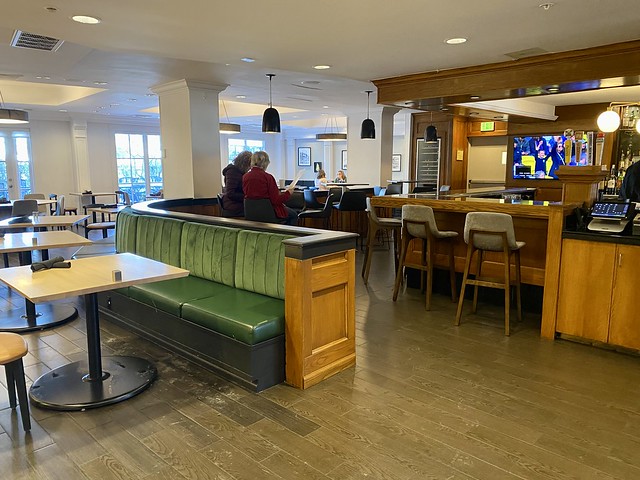 Small tables with a bank of built in seating, separates the restaurant from the bar at Crowne Plaza Portland.