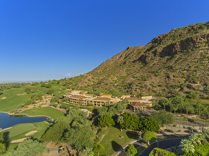 Aerial shot of Canyon Suites resort building at base of mountain