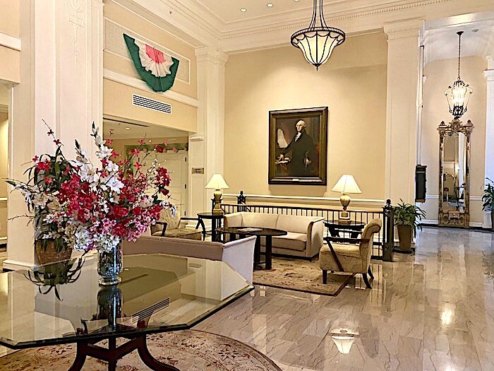 Gleaming lobby with George Washington portrait.