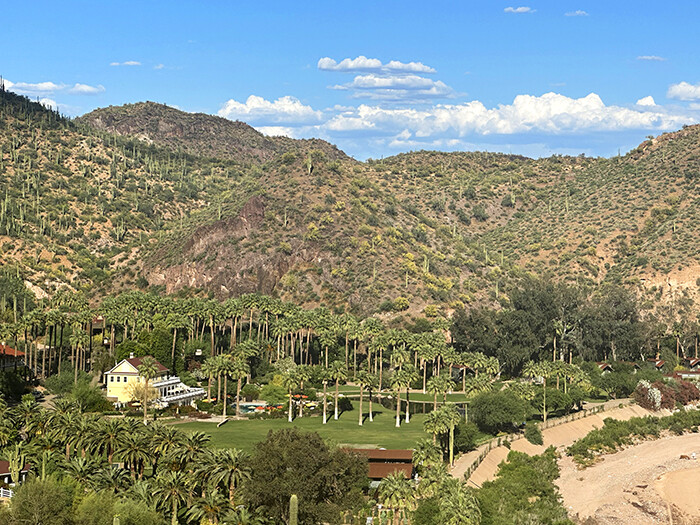 Overview of resort property shows yellow lodge and expansive lawn