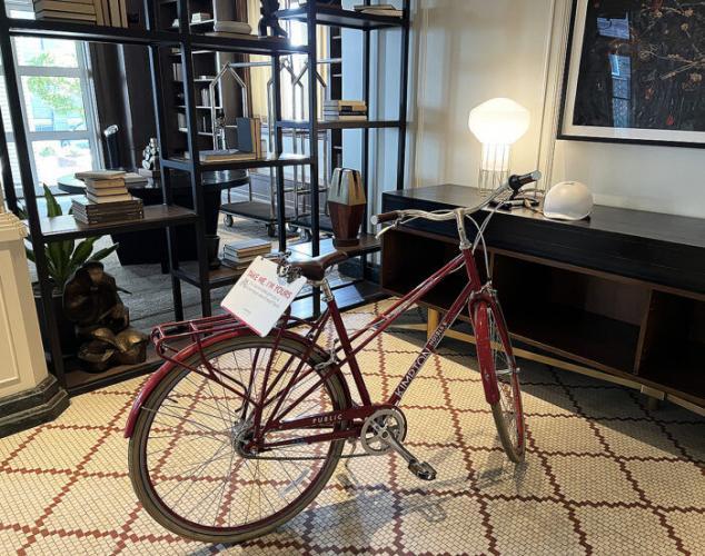 Red bicycle on historic mosaic tile lobby floor at Kimpton Cottonwood Hotel