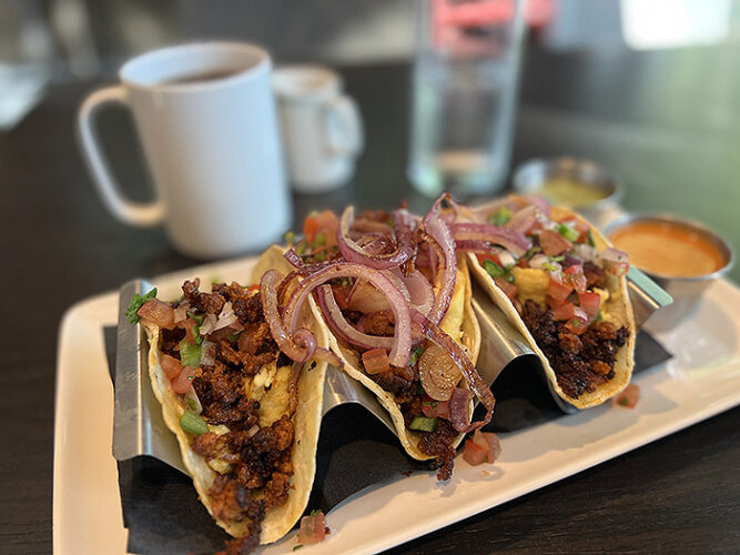 Three chorizo tacos smothered in onions.