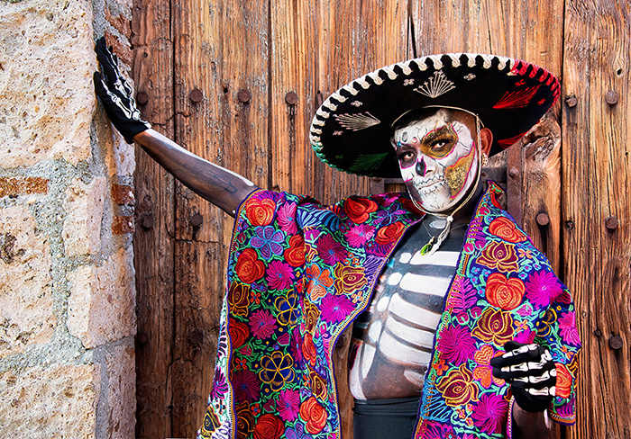 A staff member dressed up in Catrina makeup and costume