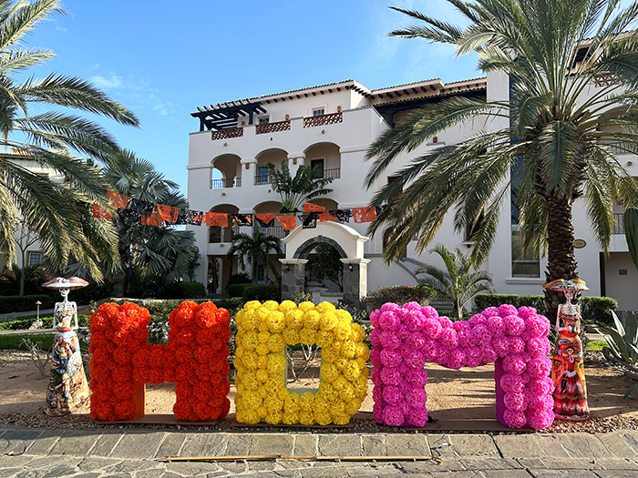 The letters HDM spelled out in paper flowers in front of resort building