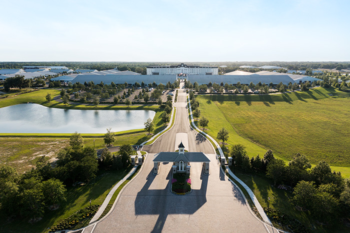 A long drive leads through the World Equestrian Center, with the Equestrian Hotel in the center surrounded by white barns