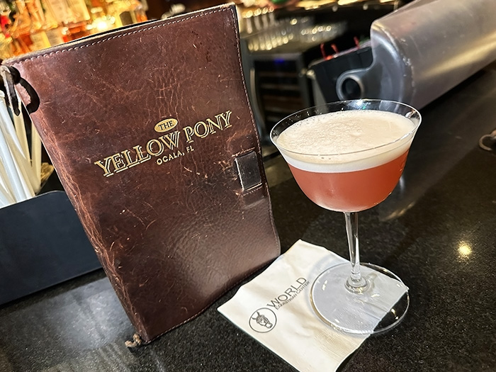 A menu from the Yellow Pony and a fruity signature cocktail