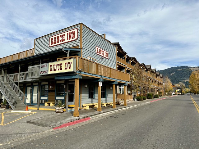 Located in downtown Jackson, the Ranch Inn is a 2-story motel. Grey siding of the motel has three Ranch Inn signs with red lettering. The motel office is on the ground floor of the 2-story property. 