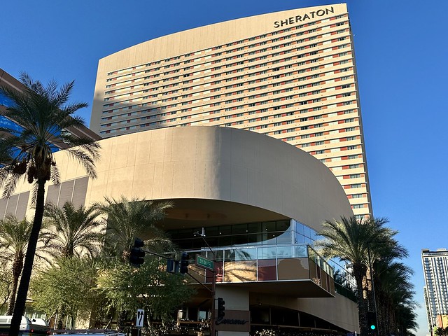 Rising 31 stories high, the Sheraton Phoenix Downtown hotel is on the corner of 3rd street in downtown Phoenix. The beige hotel is the tallest hotel in Phoenix. The Sheraton letters are spelled out on the top of the hotel. Several palm trees flank the 4 star hotel. 