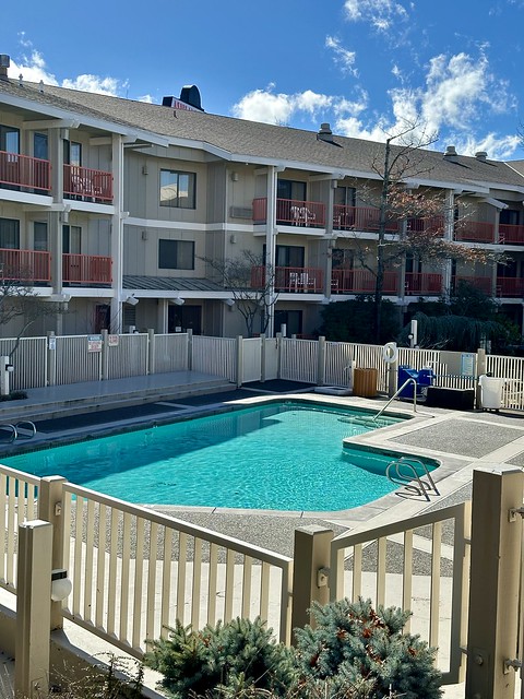 Outdoor swimming pool and 3-story hotel